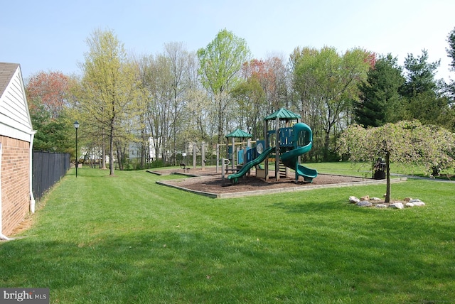 community jungle gym featuring a lawn