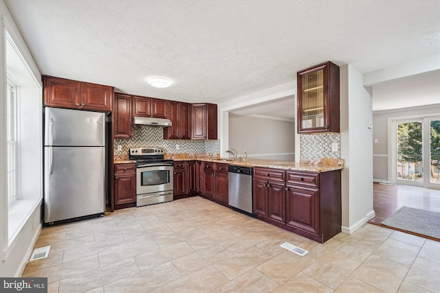 kitchen with under cabinet range hood, visible vents, backsplash, and appliances with stainless steel finishes