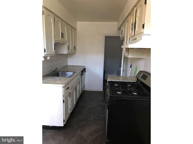 kitchen featuring stainless steel range with gas cooktop, light countertops, backsplash, a sink, and under cabinet range hood