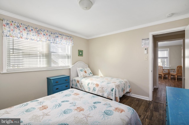 bedroom with baseboards, multiple windows, wood finished floors, and crown molding