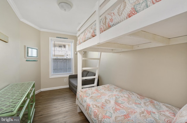 bedroom featuring ornamental molding, baseboards, and wood finished floors