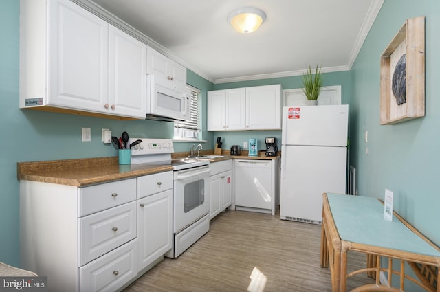 kitchen featuring a sink, dark countertops, white appliances, white cabinets, and crown molding