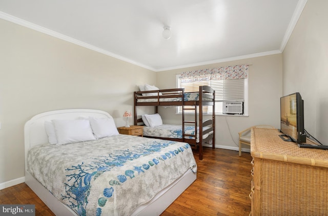 bedroom featuring baseboards, crown molding, and hardwood / wood-style flooring