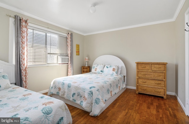 bedroom featuring baseboards, dark wood finished floors, and crown molding