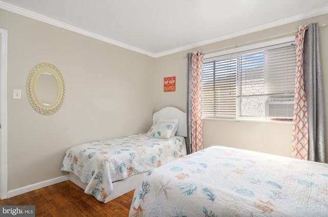 bedroom featuring crown molding, wood finished floors, and baseboards