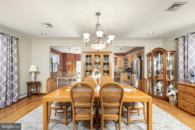 dining room with light wood-type flooring, recessed lighting, visible vents, and a chandelier