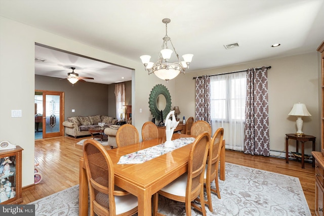 dining space featuring recessed lighting, visible vents, ceiling fan with notable chandelier, and light wood-type flooring