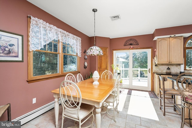 dining area featuring a baseboard heating unit, baseboards, and visible vents