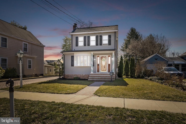 view of front of home featuring a front yard and a chimney