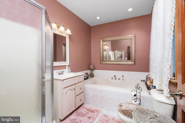 bathroom featuring vanity, a garden tub, recessed lighting, and tile patterned floors