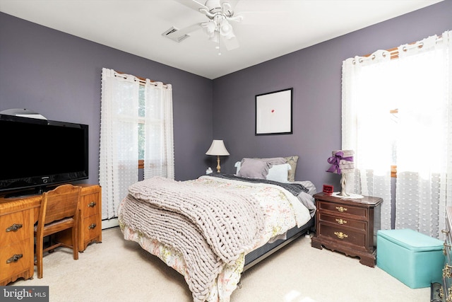 carpeted bedroom featuring visible vents and ceiling fan