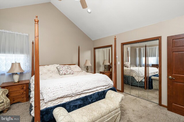 bedroom featuring multiple closets, carpet, baseboards, ceiling fan, and vaulted ceiling