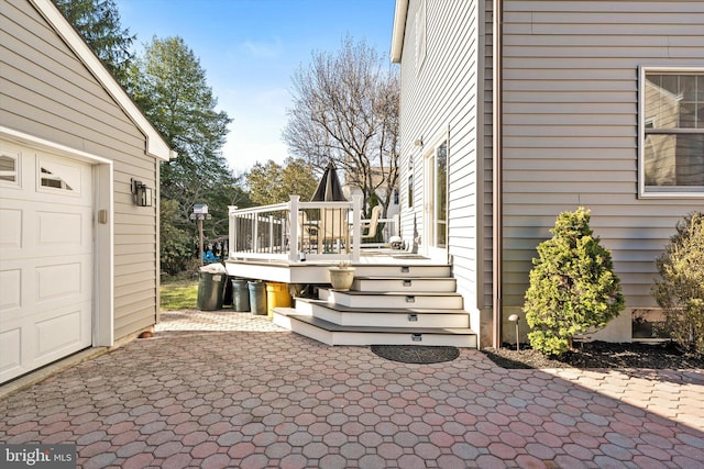 view of patio with a deck and an attached garage