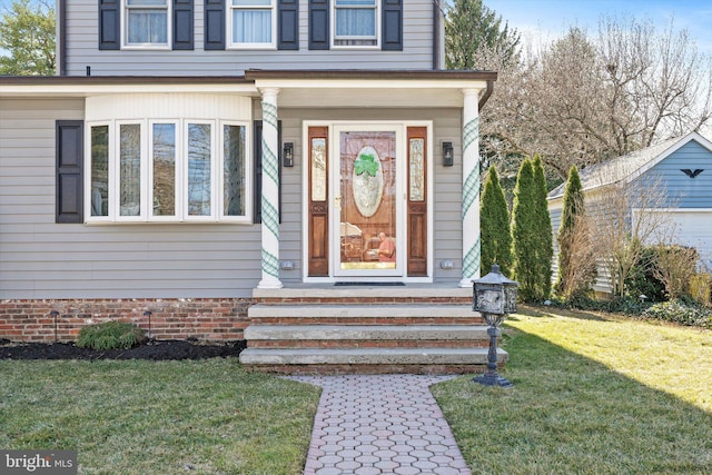 doorway to property featuring a yard