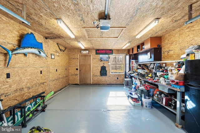 garage with a workshop area and a garage door opener