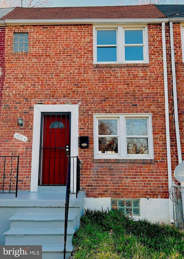 view of front of home featuring brick siding