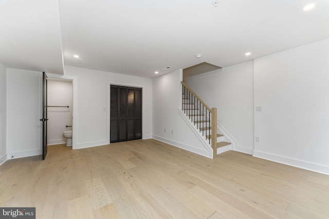 interior space featuring recessed lighting, stairway, baseboards, and light wood-style flooring