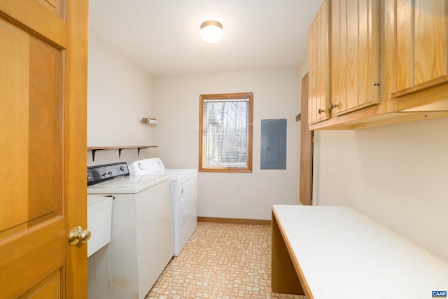 laundry area featuring baseboards, electric panel, cabinet space, and washing machine and clothes dryer