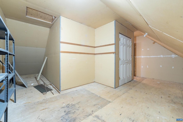 additional living space with attic access and vaulted ceiling