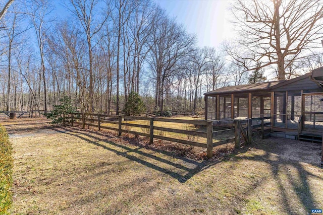 view of yard with a sunroom and fence