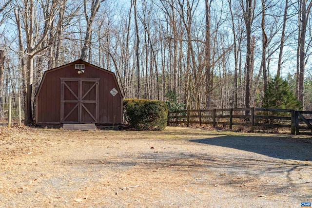 view of outbuilding with an outdoor structure and fence