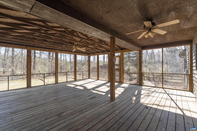 unfurnished sunroom with ceiling fan