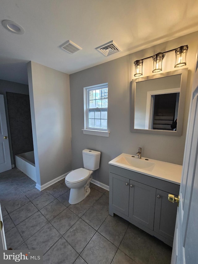 bathroom featuring baseboards, visible vents, vanity, and toilet