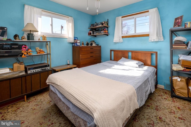 carpeted bedroom featuring visible vents and baseboards