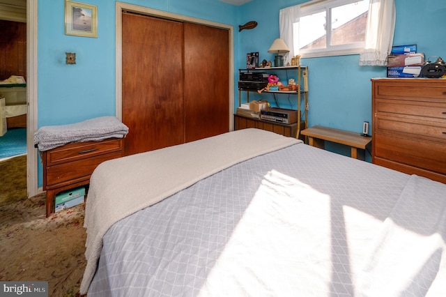 carpeted bedroom with a closet