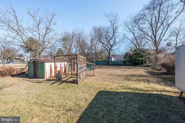 view of yard with an outdoor structure, exterior structure, and fence