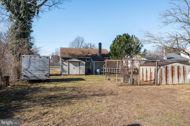 view of yard with an outbuilding, fence, and a shed