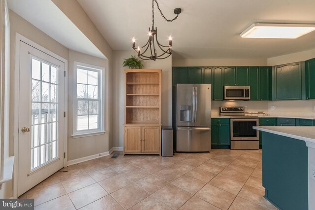 kitchen with light countertops, light tile patterned floors, green cabinetry, and stainless steel appliances