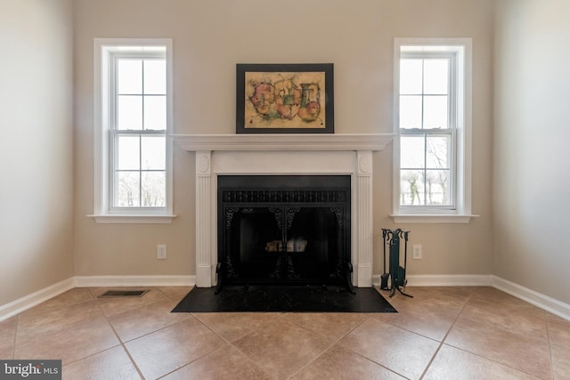 interior details featuring visible vents, a fireplace with flush hearth, and baseboards