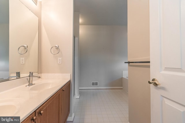 full bath with tile patterned floors, visible vents, double vanity, and a sink