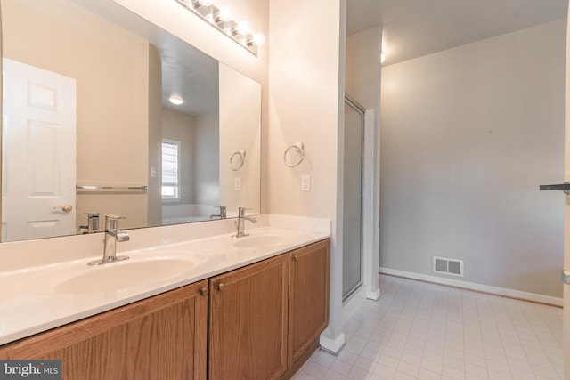 full bath featuring a sink, visible vents, double vanity, and tile patterned flooring