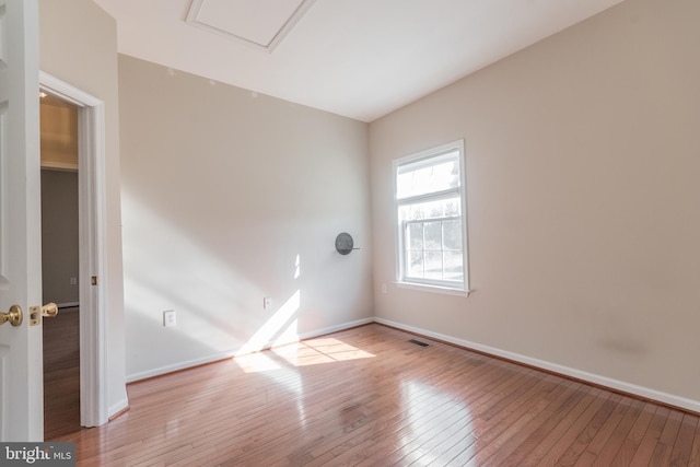 unfurnished room featuring visible vents, baseboards, and light wood-style floors