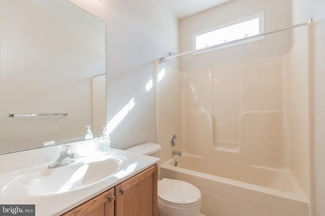 bathroom with vanity, shower / bathing tub combination, and toilet