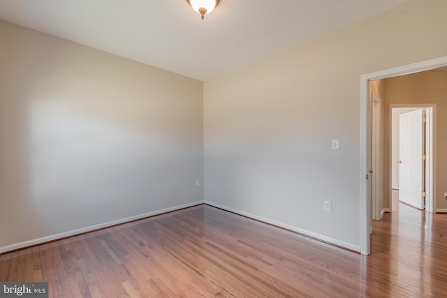 unfurnished room featuring wood finished floors and baseboards