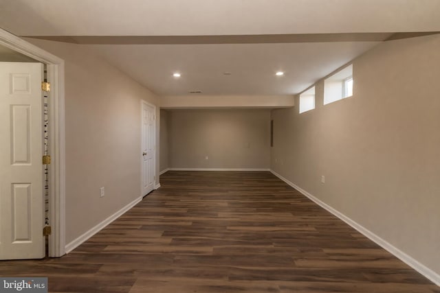 below grade area featuring recessed lighting, dark wood-type flooring, and baseboards