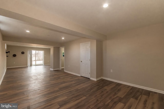 empty room with recessed lighting, baseboards, and dark wood-type flooring