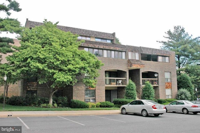 view of building exterior with uncovered parking