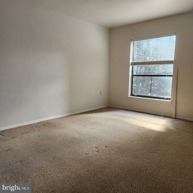 empty room with light carpet and baseboards