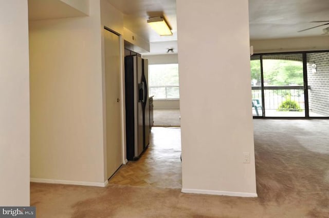 hall with light carpet and baseboards