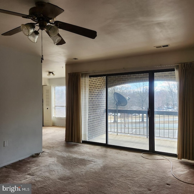 spare room with visible vents and carpet flooring