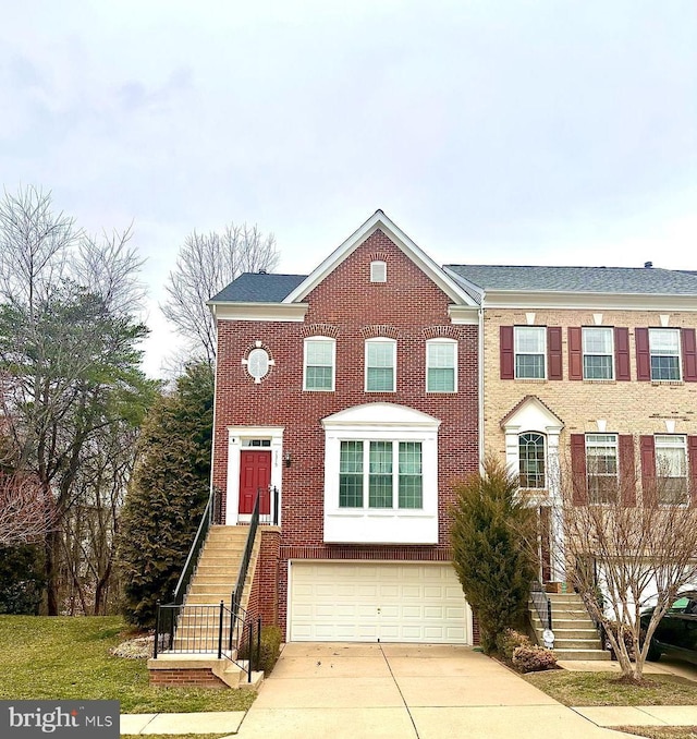 view of property featuring concrete driveway, brick siding, stairway, and an attached garage