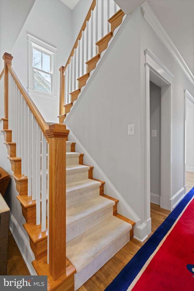 stairs featuring baseboards and wood finished floors