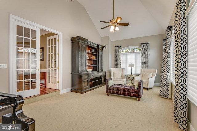 sitting room featuring baseboards, carpet floors, high vaulted ceiling, ceiling fan, and french doors