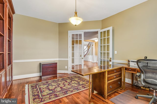 office space featuring french doors, baseboards, and hardwood / wood-style flooring