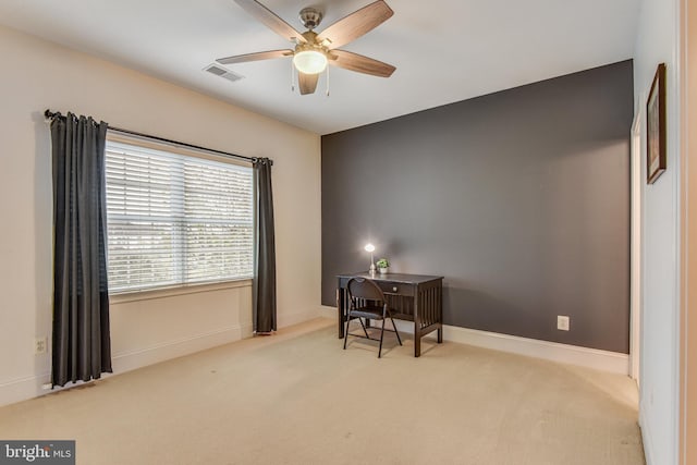 carpeted office space featuring visible vents, baseboards, and ceiling fan