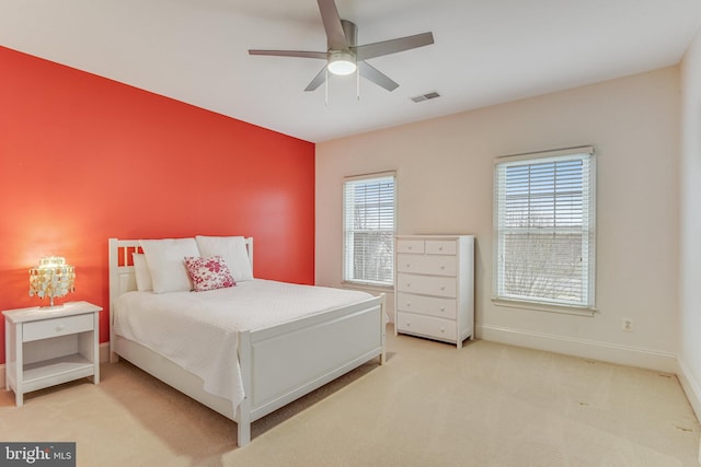 bedroom with ceiling fan, carpet, visible vents, and baseboards